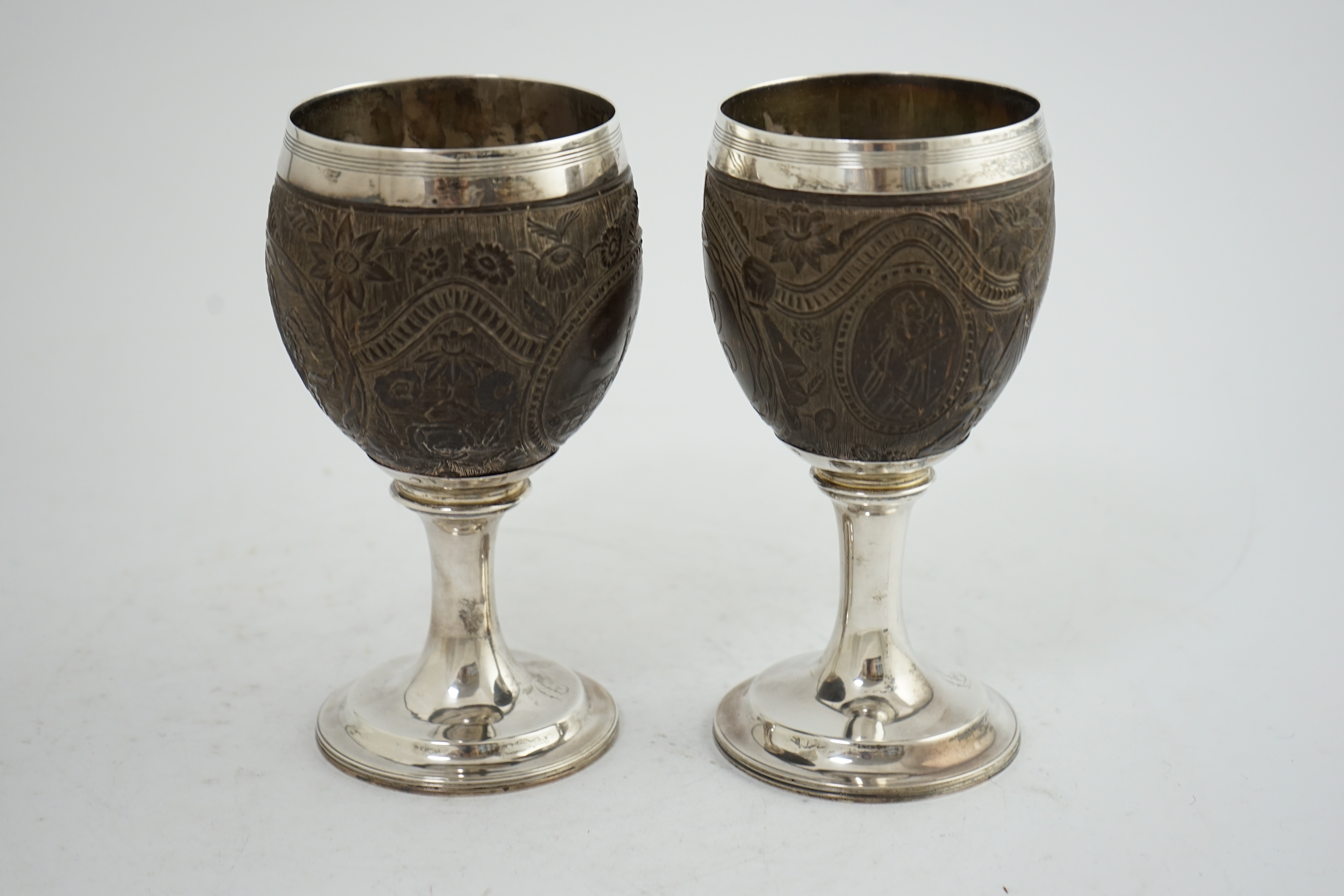 A pair of George III silver mounted coconut cups, maker I.T?